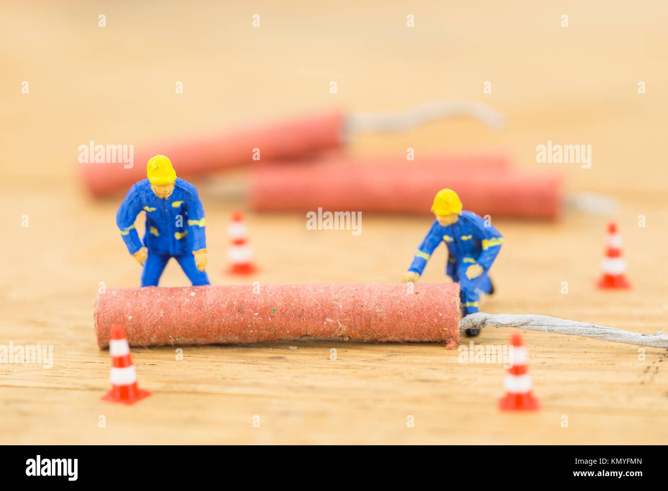 Concept miniature people working hard on Firecracker Stock Photo - Alamy