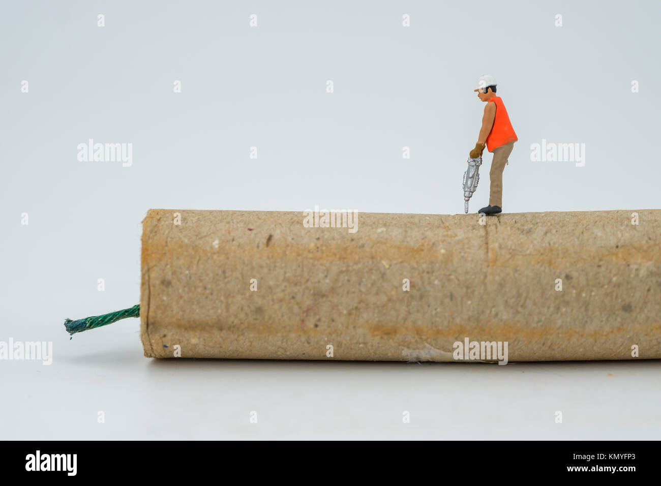 Concept miniature people destroying a Firecracker or dynamite Stock Photo