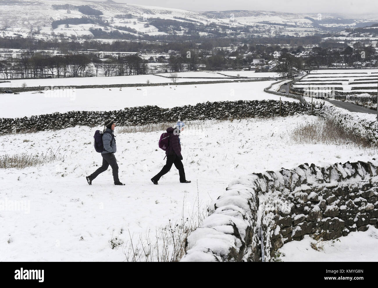 Walkers in the Peak District, as widespread disruption is expected as snow continues to fall across large parts of the UK, with forecasters warning some communities could be cut off as temperatures plummet. Stock Photo