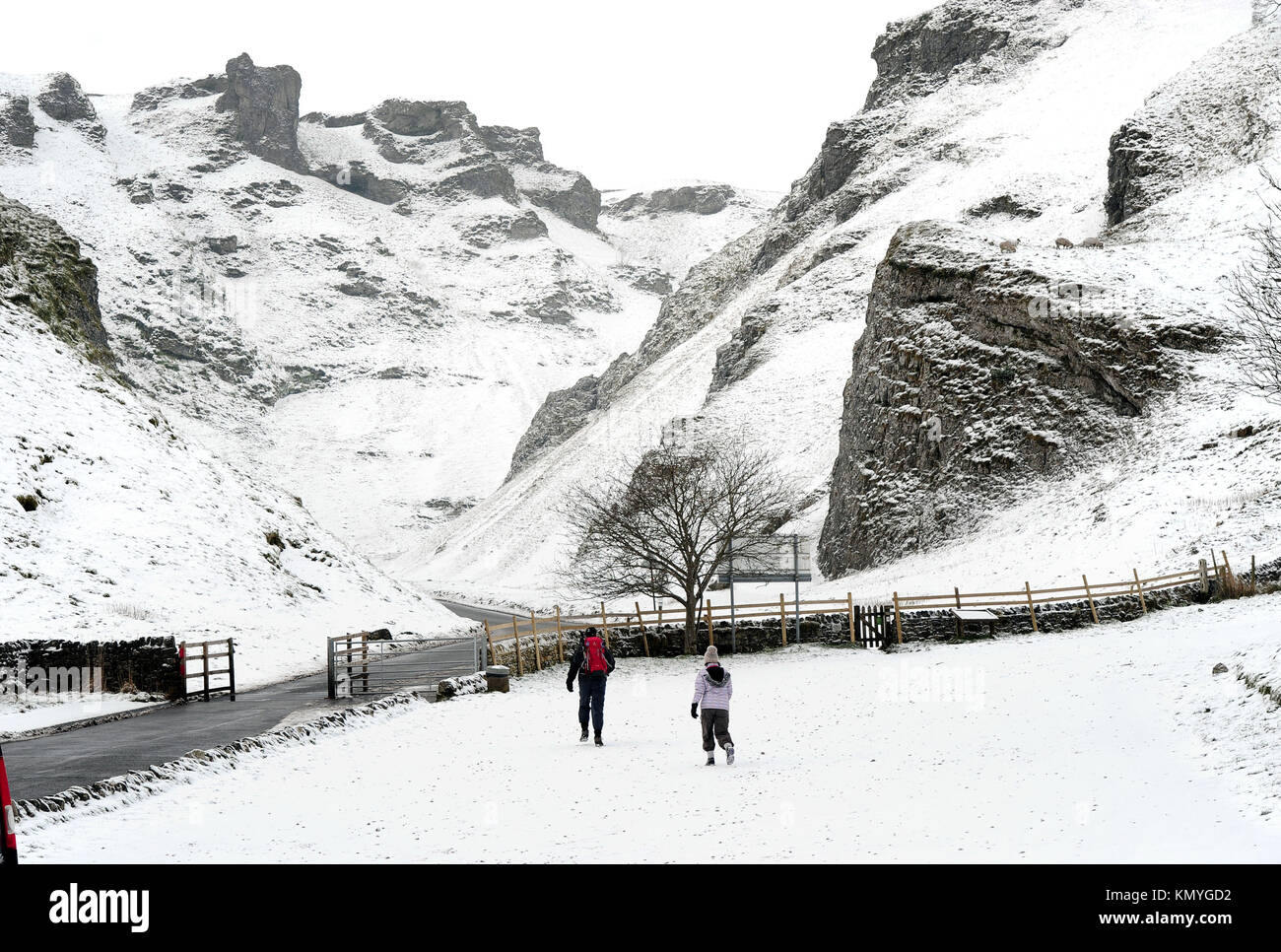 Walkers at Winnats Pass in the Peak District, as widespread disruption is expected as snow continues to fall across large parts of the UK, with forecasters warning some communities could be cut off as temperatures plummet. Stock Photo
