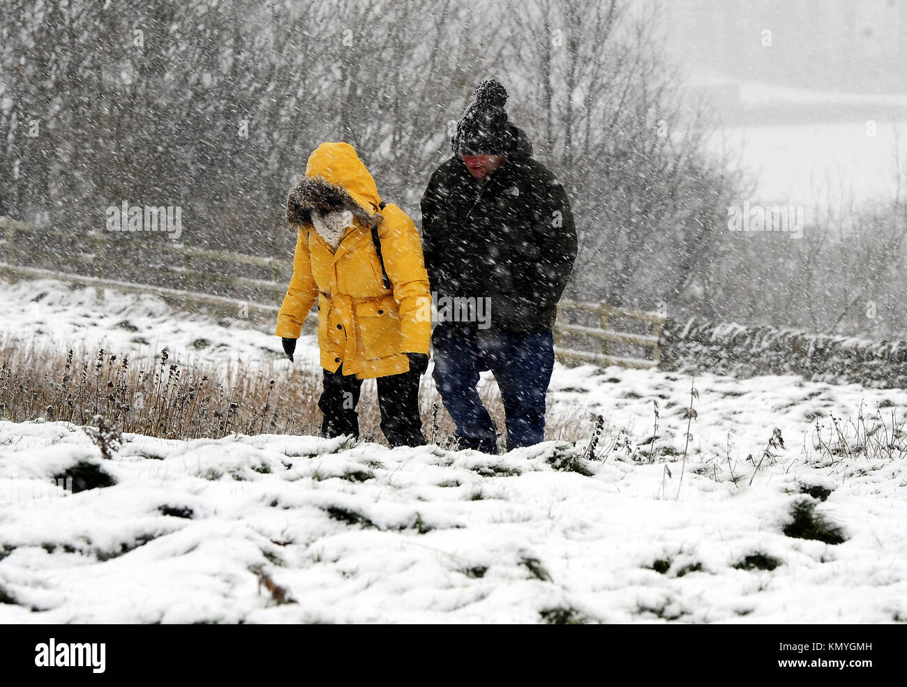 Walkers out in the snow near Castleton in the Peak District, as widespread disruption is expected as snow continues to fall across large parts of the UK, with forecasters warning some communities could be cut off as temperatures plummet. Stock Photo