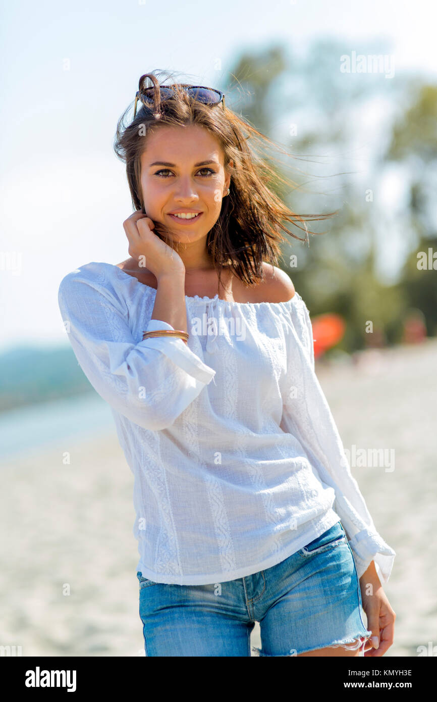 Beautiful young woman posing on a windy summer day Stock Photo Alamy