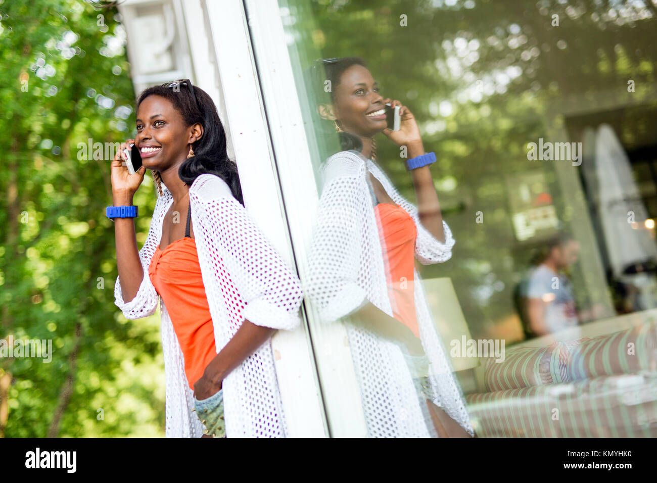 Beautiful black woman talking on phone and smiling Stock Photo - Alamy