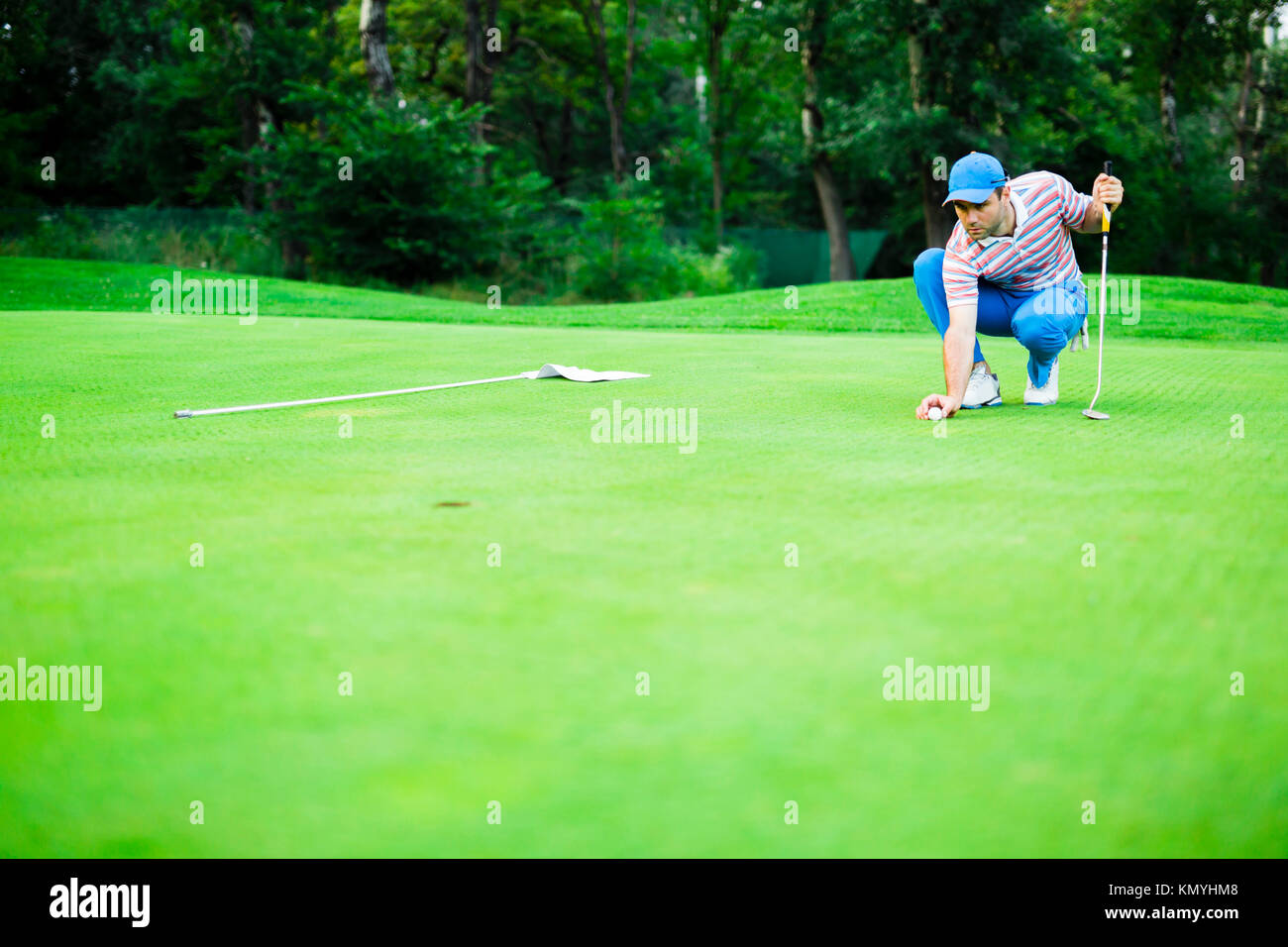 Golf player marking ball on the putting green Stock Photo Alamy