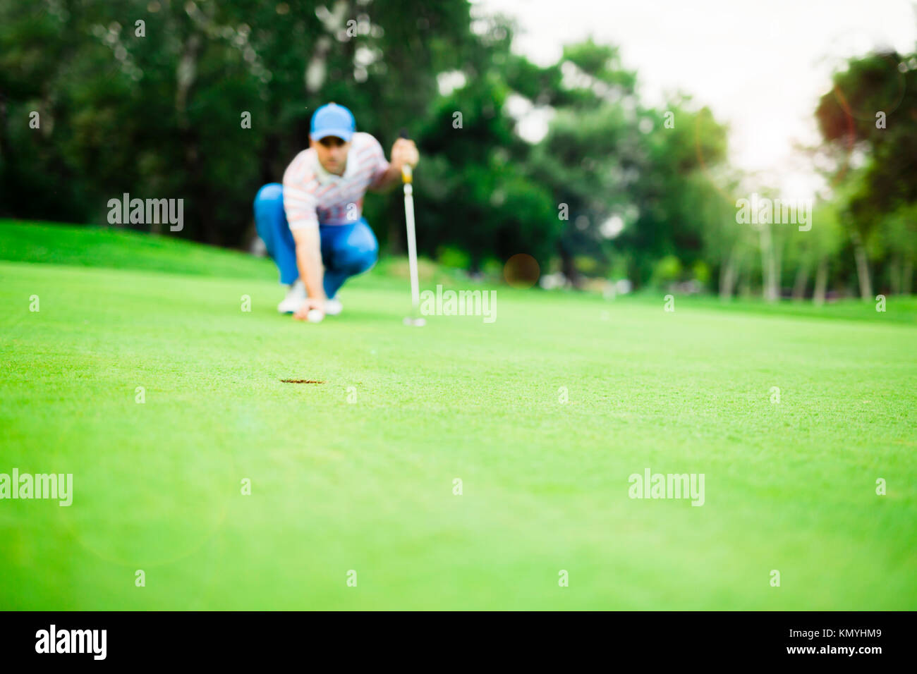 Golf player marking ball on the putting green Stock Photo Alamy