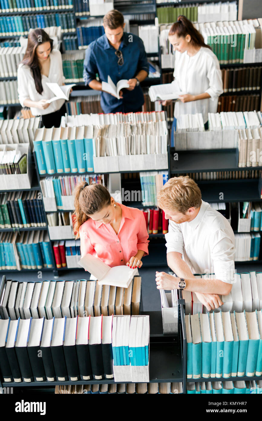 Students learning, reading in the library Stock Photo - Alamy