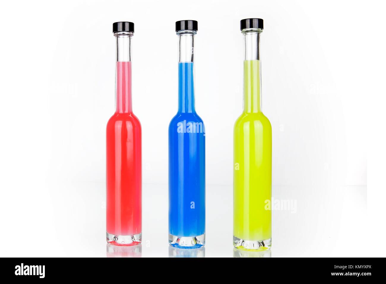 Download Three Glass Bottles With Colored Drinks In Red Blue Yellow Stock Photo Alamy PSD Mockup Templates