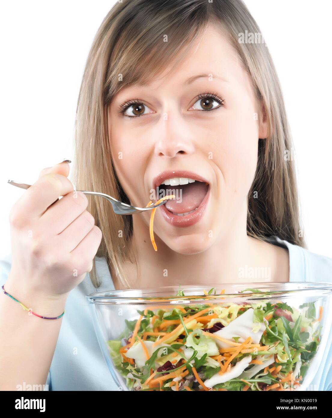 Portrait of young happy woman eating salad Stock Photo Alamy