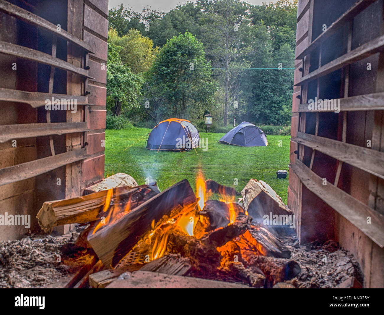 View of the camping at the Wieprza river through the fire place Stock Photo