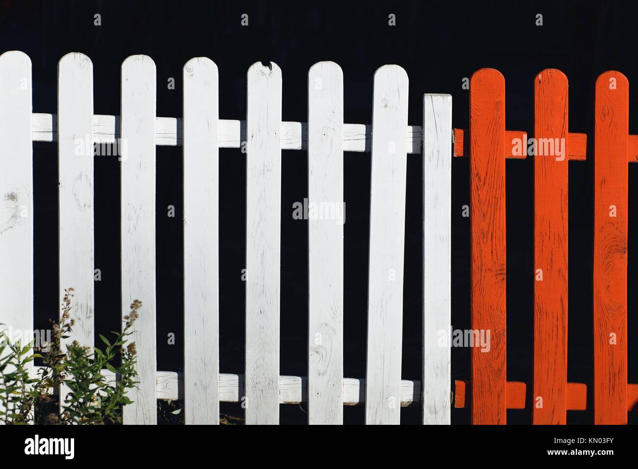 Red and white picket fence Stock Photo