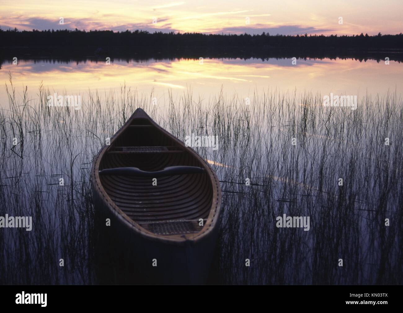 an open canadian canoe on a lake in canada made by native indians in