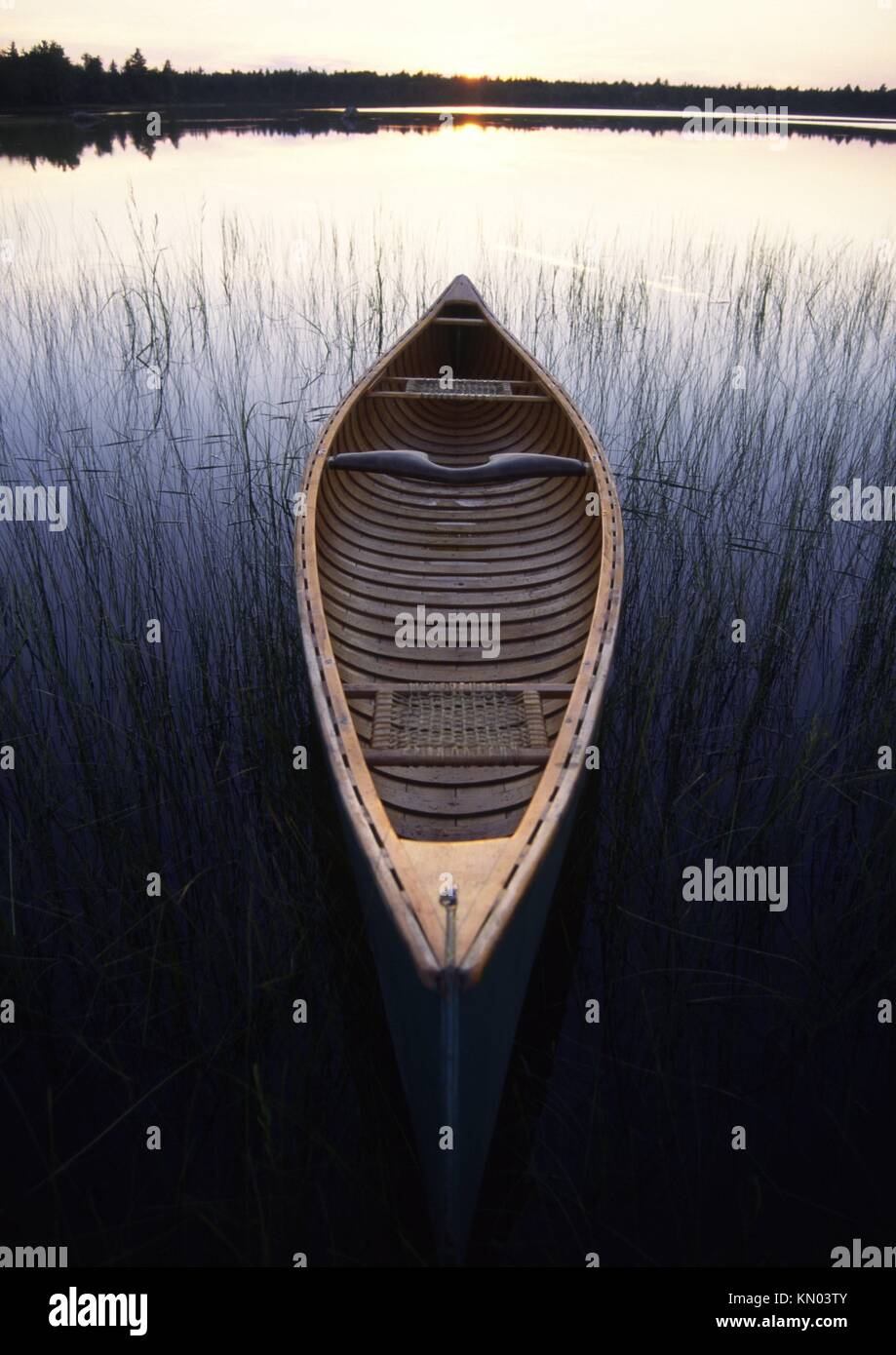 an open canadian canoe on a lake in canada made by native indians in