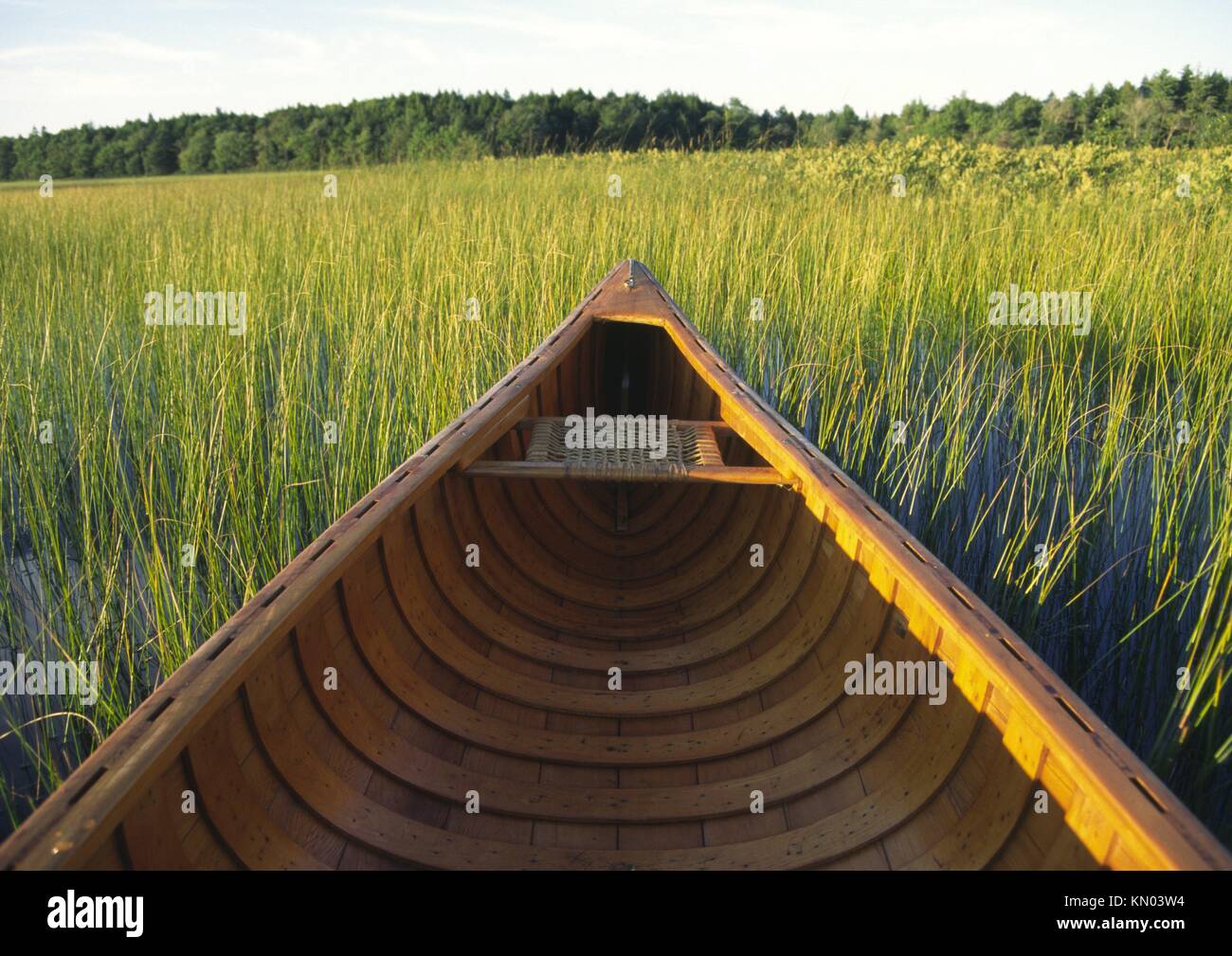 an open canadian canoe on a lake in canada made by native indians in
