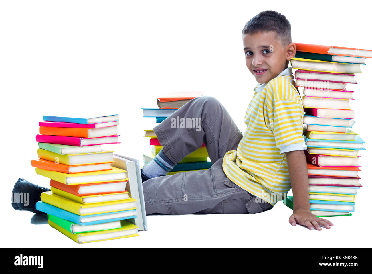 schoolboy sitting on the flor surrounded with books Stock Photo
