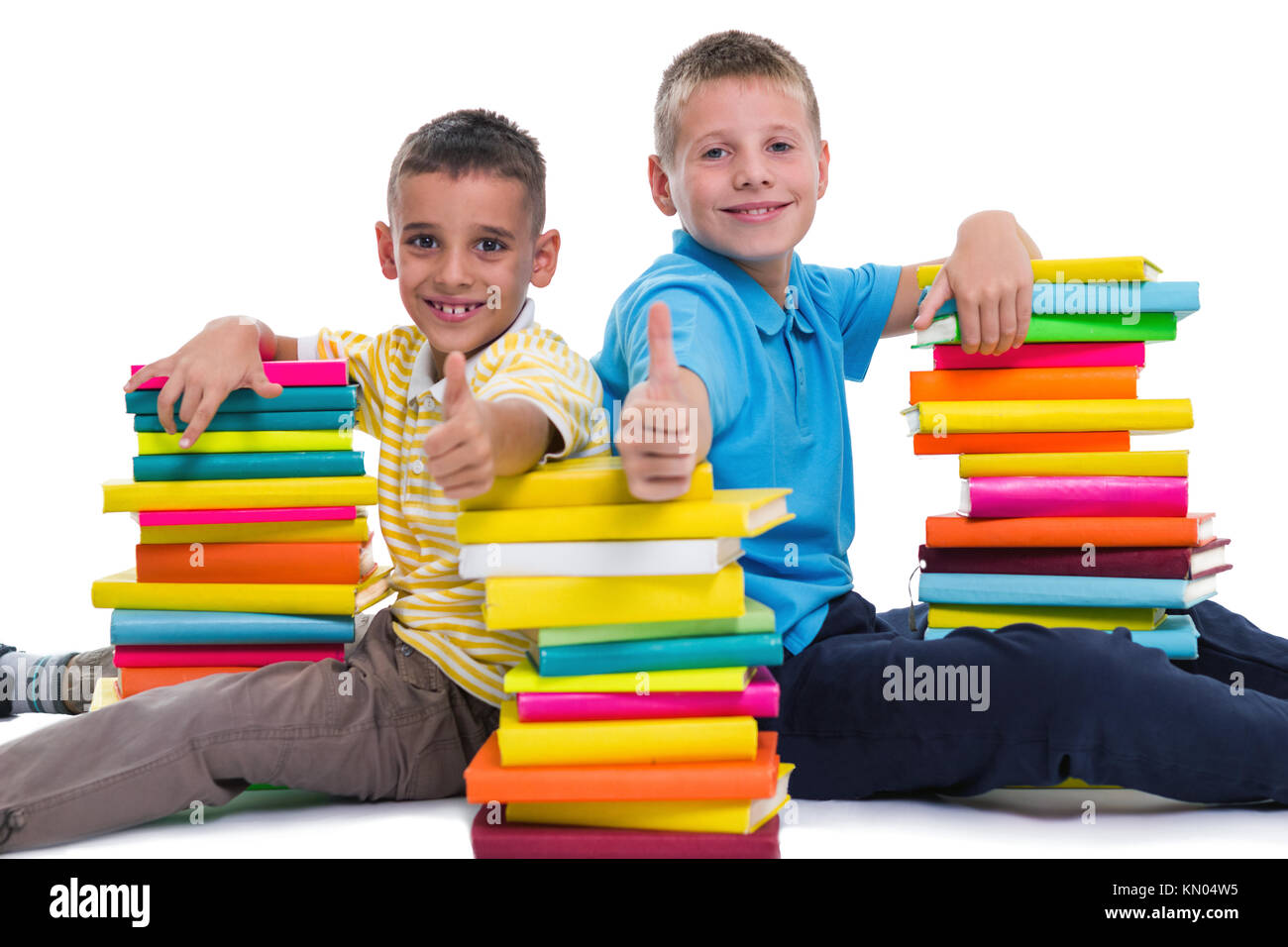 two smiling schoolboys showing thumbs up gesture Stock Photo