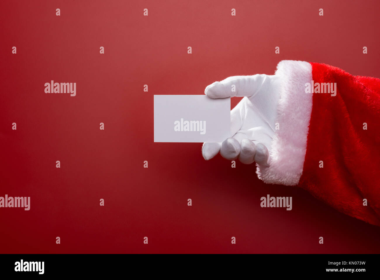Santa Claus holding a white blank card good for test on red background ...