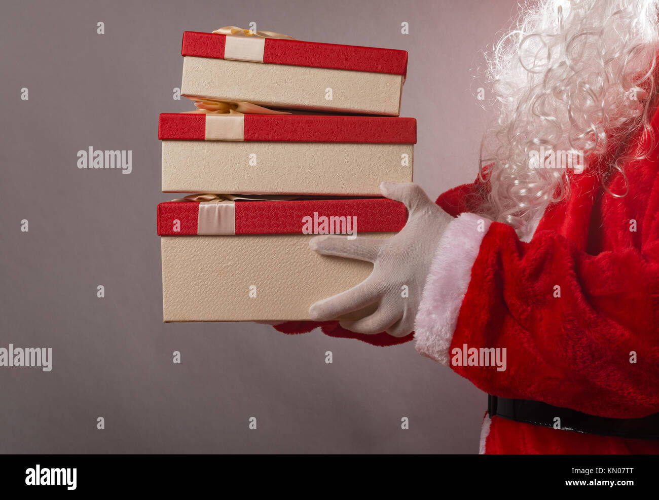 Santa Claus holding some gift boxes Stock Photo - Alamy