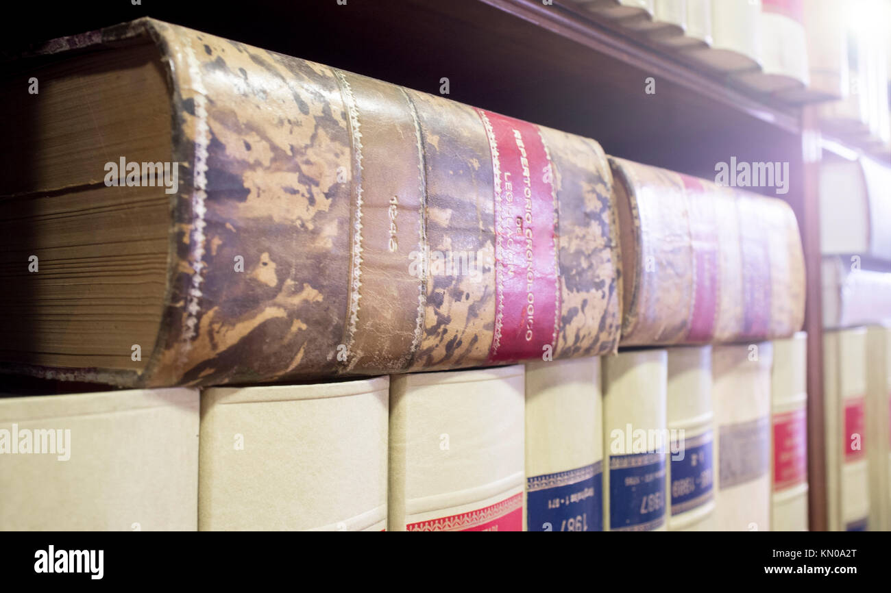 Bookshelf plenty of old legal books. Library law background Stock Photo