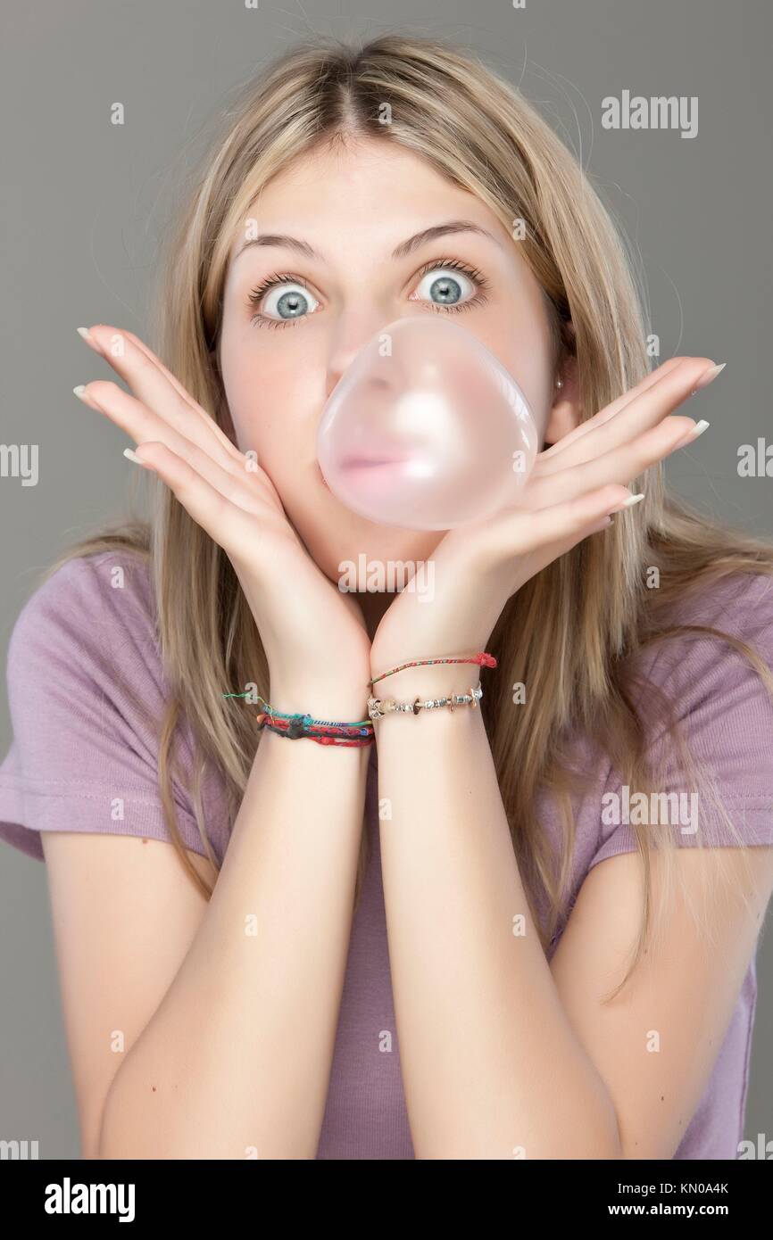 Beautiful girl making a bubble from chewing gum Stock Photo Alamy