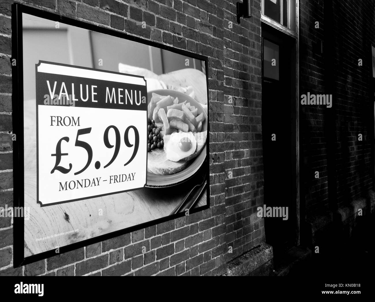 Value menu advertising poster on side wall of public house Stock Photo