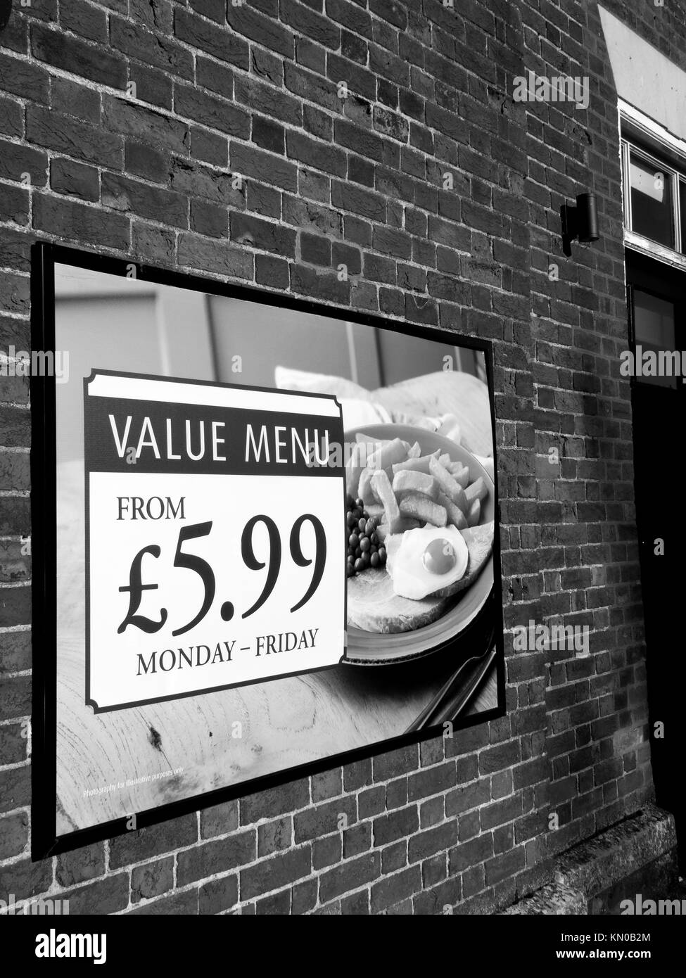 Value menu advertising poster on side wall of public house Stock Photo