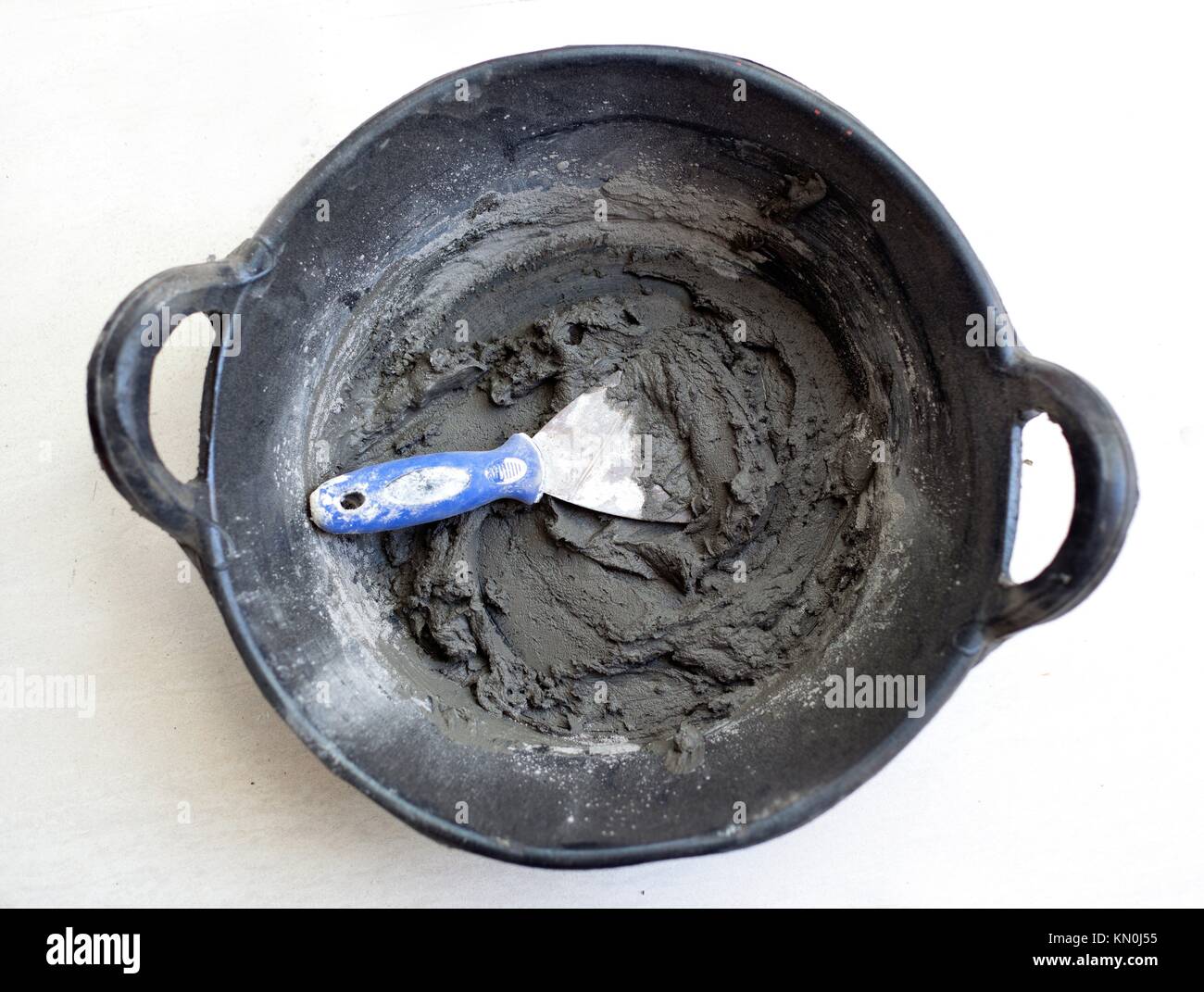 cement portland gray fresh mortar mix with spatula tool in bucket Stock