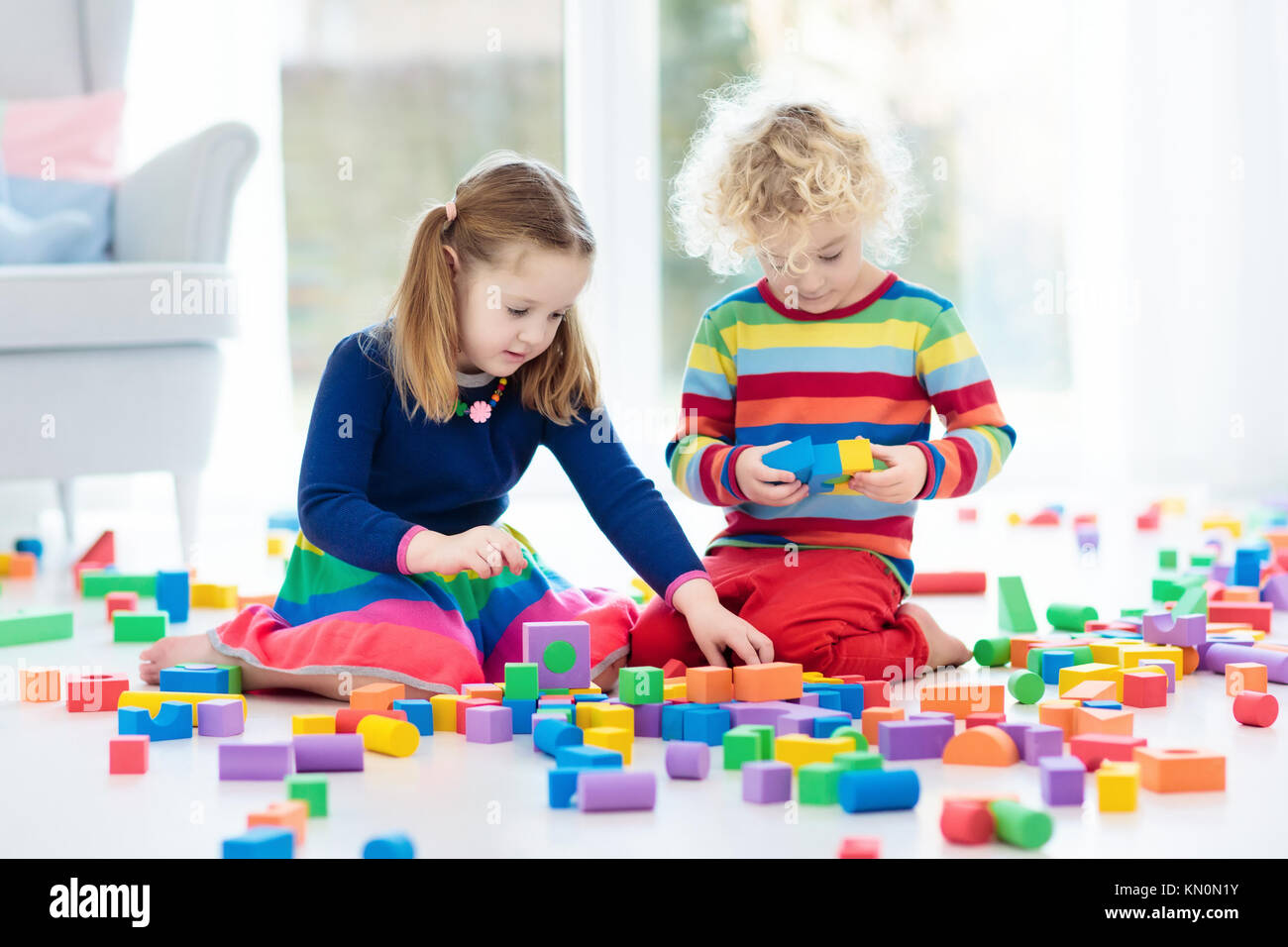 Kids play with wooden toy blocks. Educational colorful toys for ...