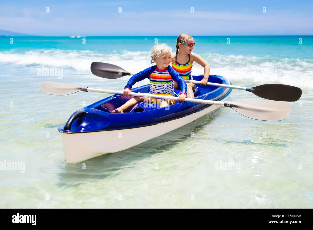 Kids kayaking in ocean. Children in kayak in tropical sea. Active Stock