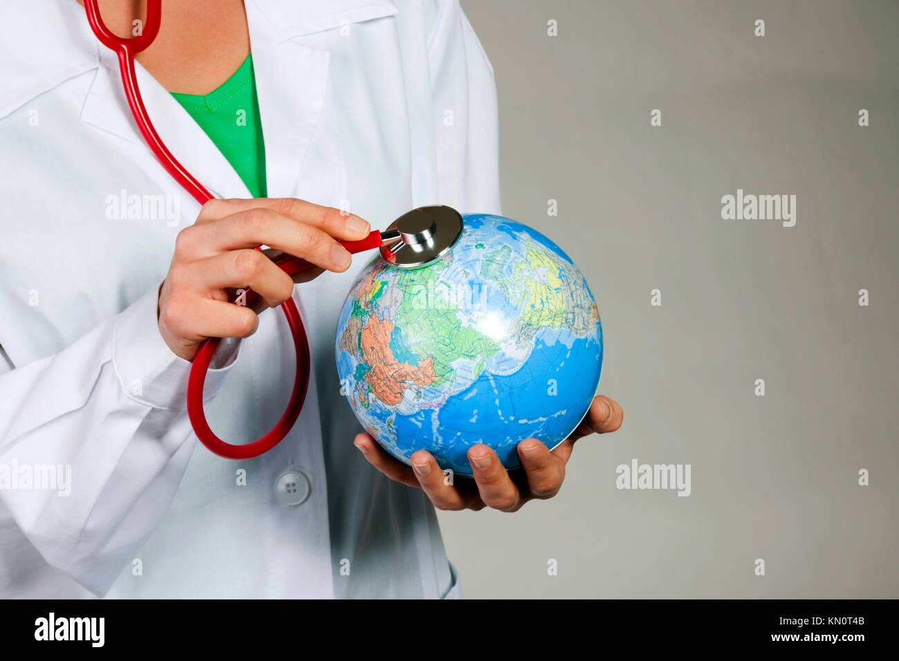 Female doctor listening to the Earth with stethoscope Stock Photo - Alamy