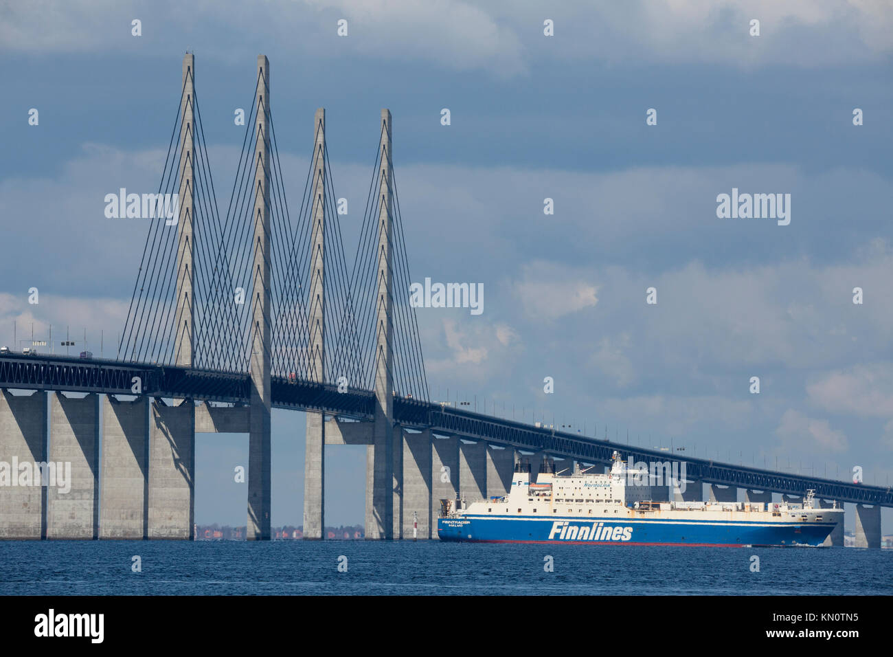 Commercial vessel passes The Øresund Bridge Stock Photo