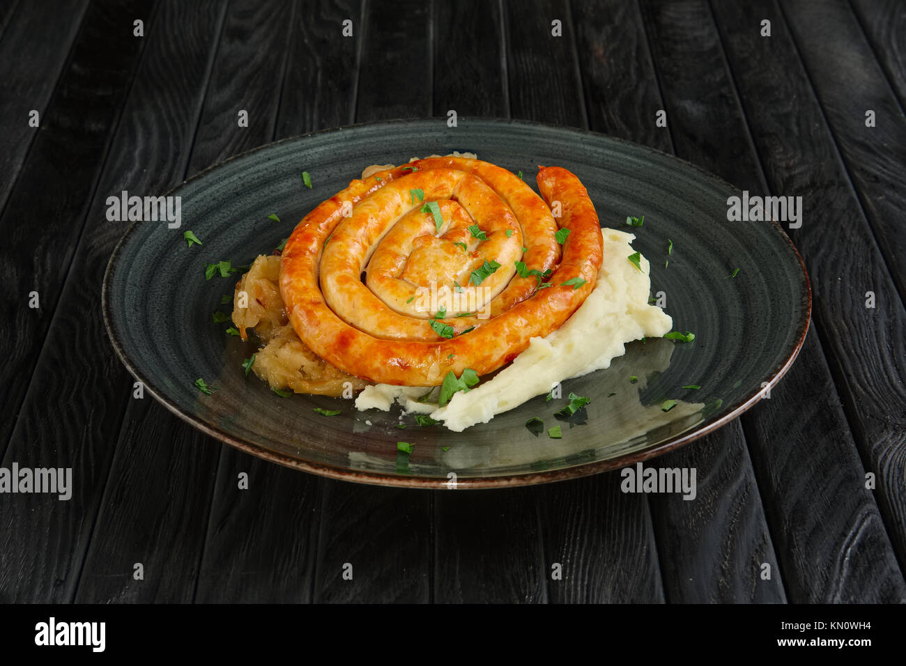 Fried homemade sausage with mashed potato and braised cabbage Stock Photo