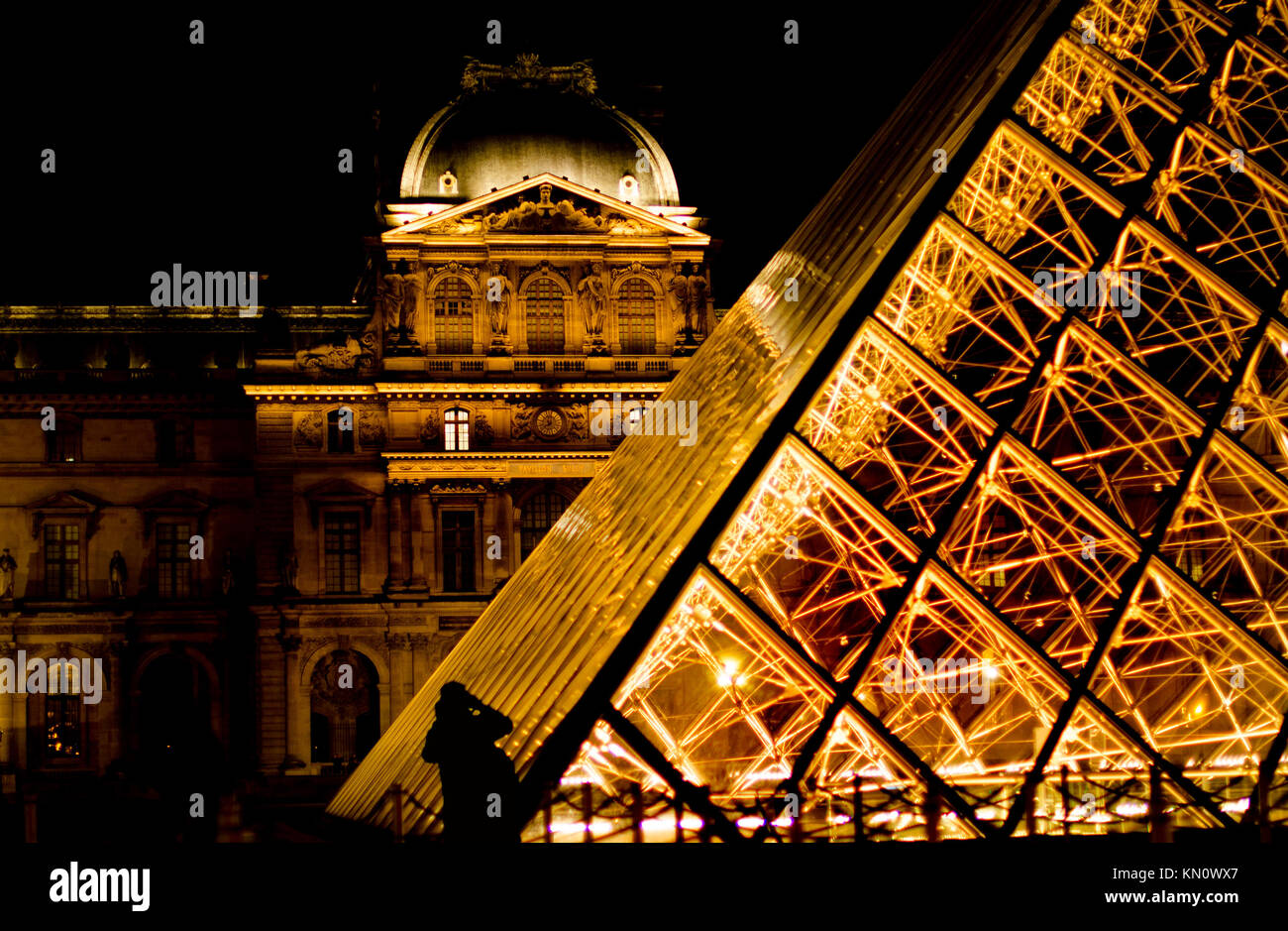 Paris, France. Palais du Louvre and I M Pei's Pyramide du Louvre / Louvre Pyramid (1989) at night. Stock Photo