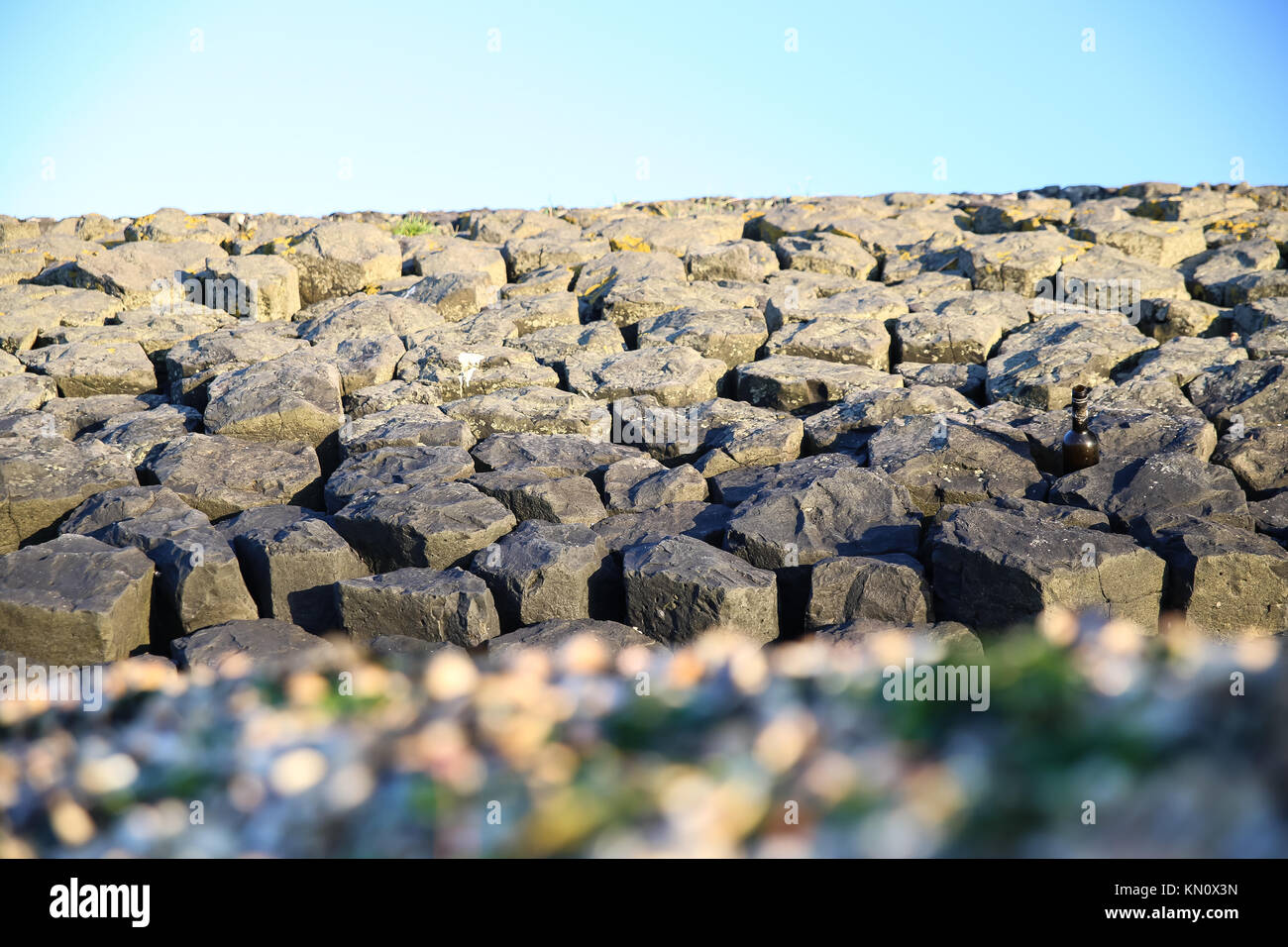 Stone wall on the beach Stock Photo