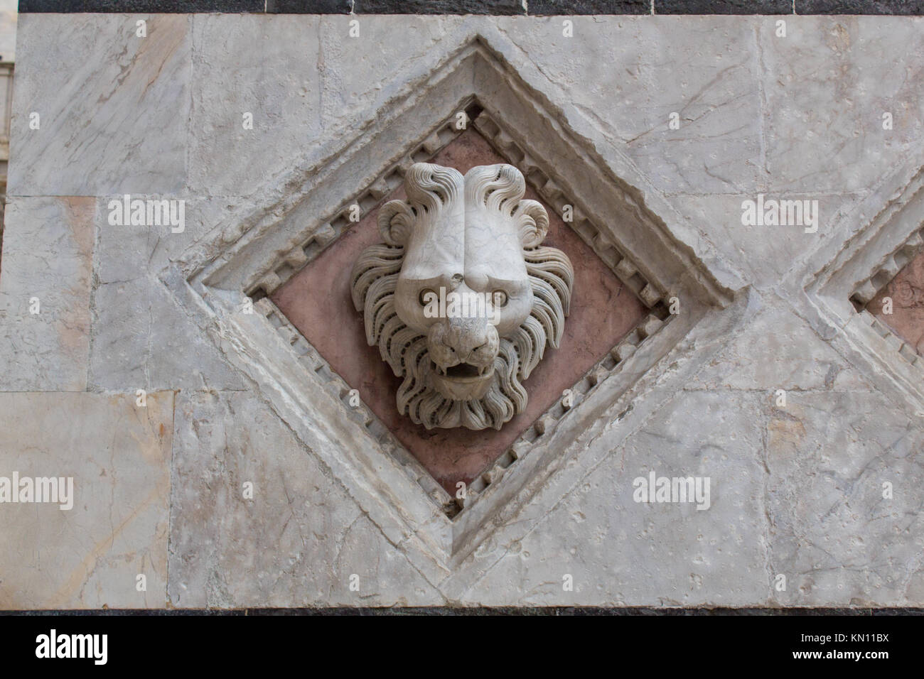 Carved lion's head exterior element on the Duomo di Siena. Stock Photo