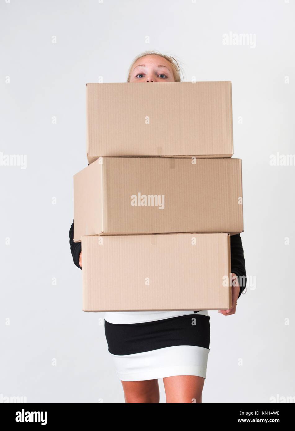 Young adult female carry a stack of boxes during a move from one office to  another Stock Photo - Alamy