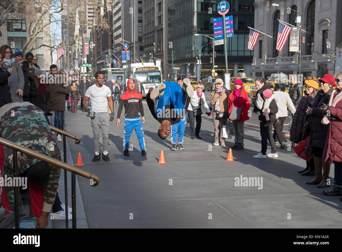 Athletic acrobatic dancers perform for donations on Fifth Avenue in Midtown Manhattan, New York City.donations, mopney Stock Photo