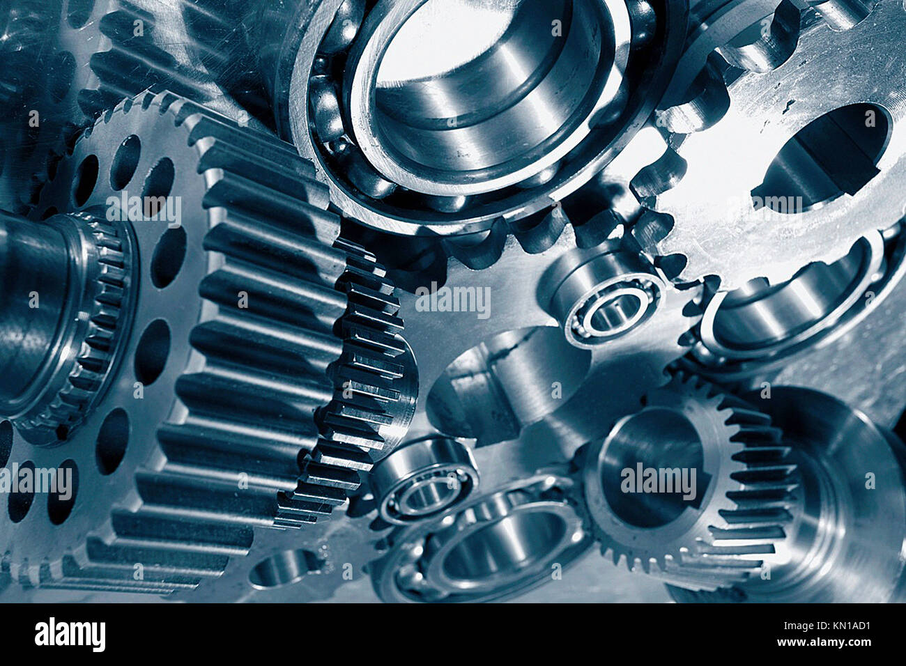 machine parts, gear wheels, cogs and ball bearings against steel, blue