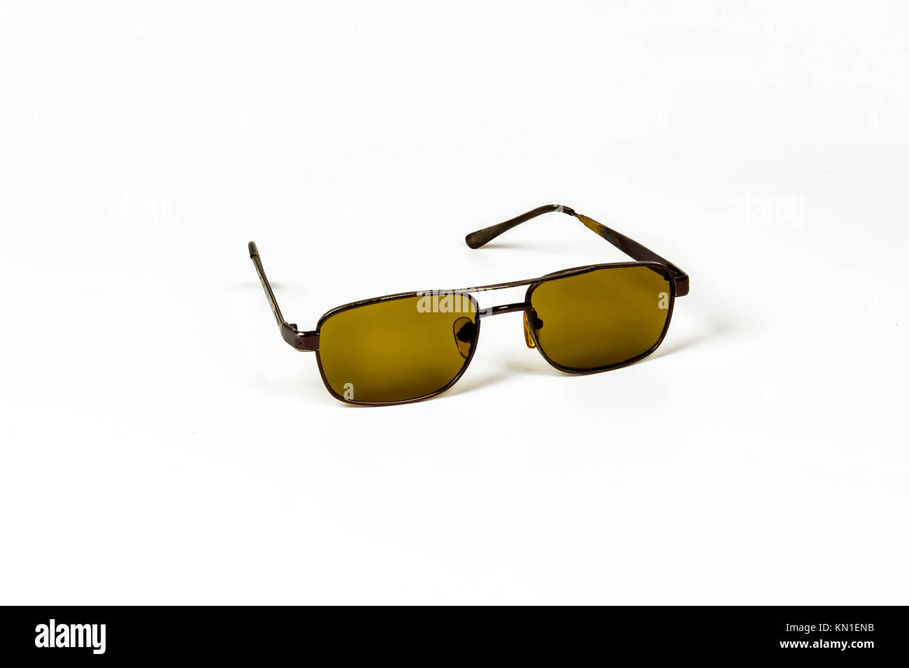 On a white background are men's sunglasses with dark glasses Stock