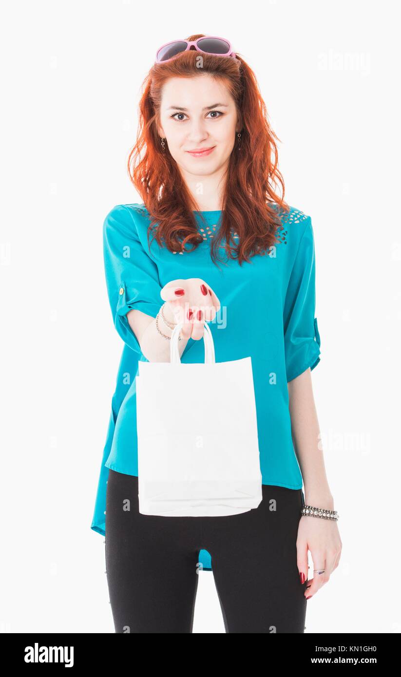 Studio portrait of attractive young woman with shopping bags and sunglasses. Stock Photo