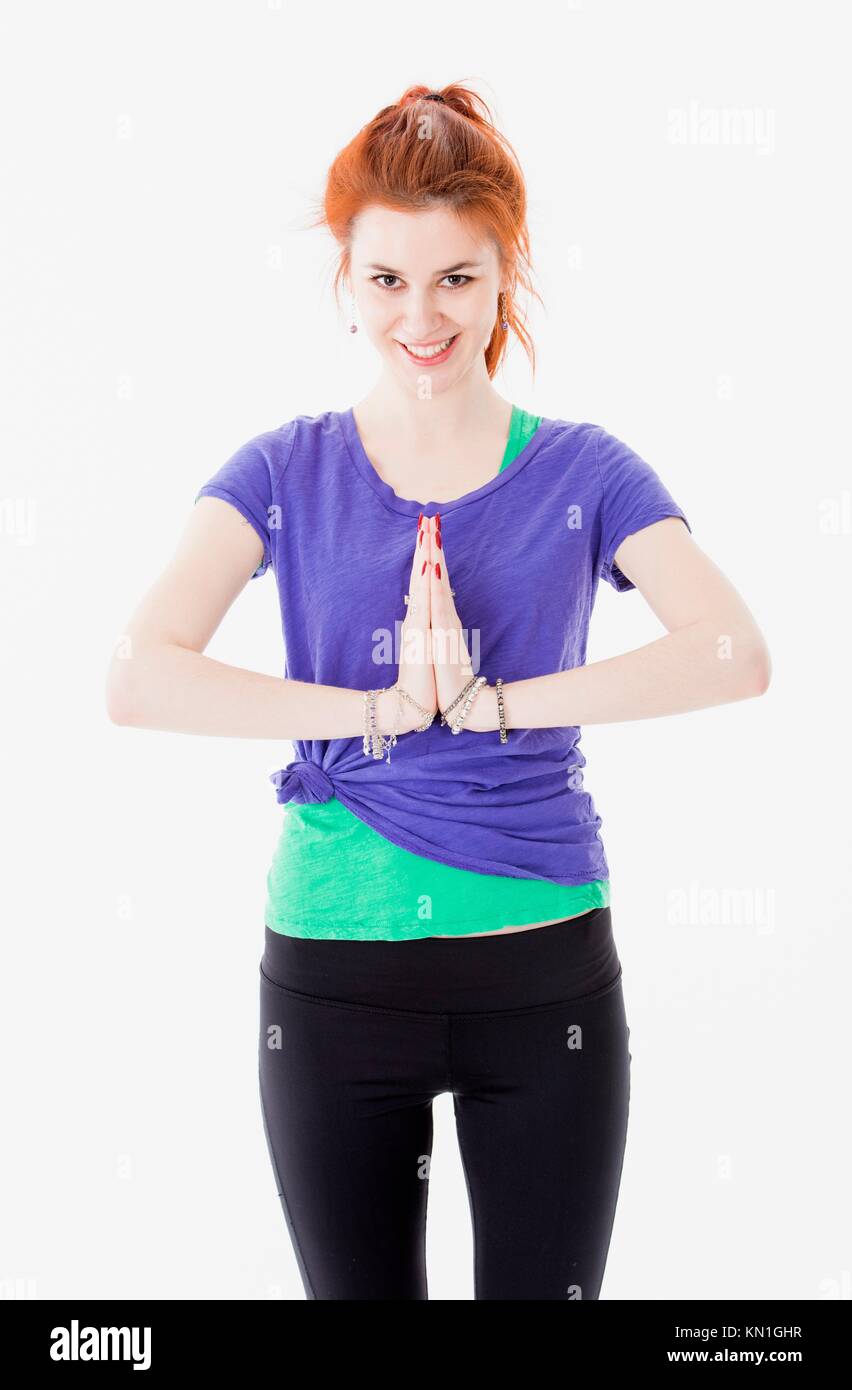 Studio portrait of attractive young woman with red hair training yoga. Stock Photo