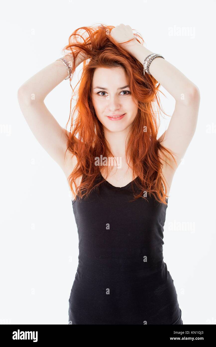 Portrait of attractive young woman with red hair and black dress. Stock Photo