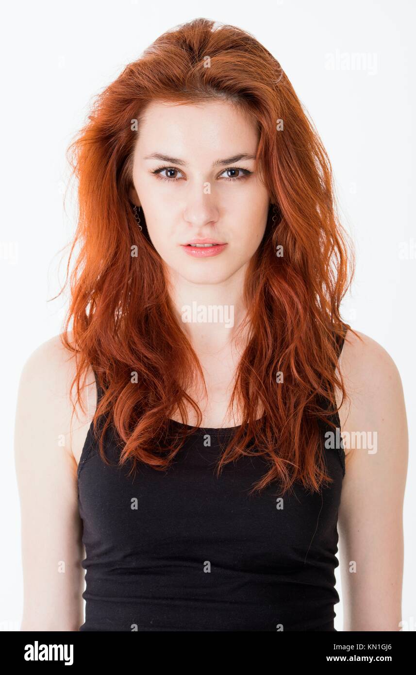 Portrait of emotional and upset young woman with red hair. Stock Photo
