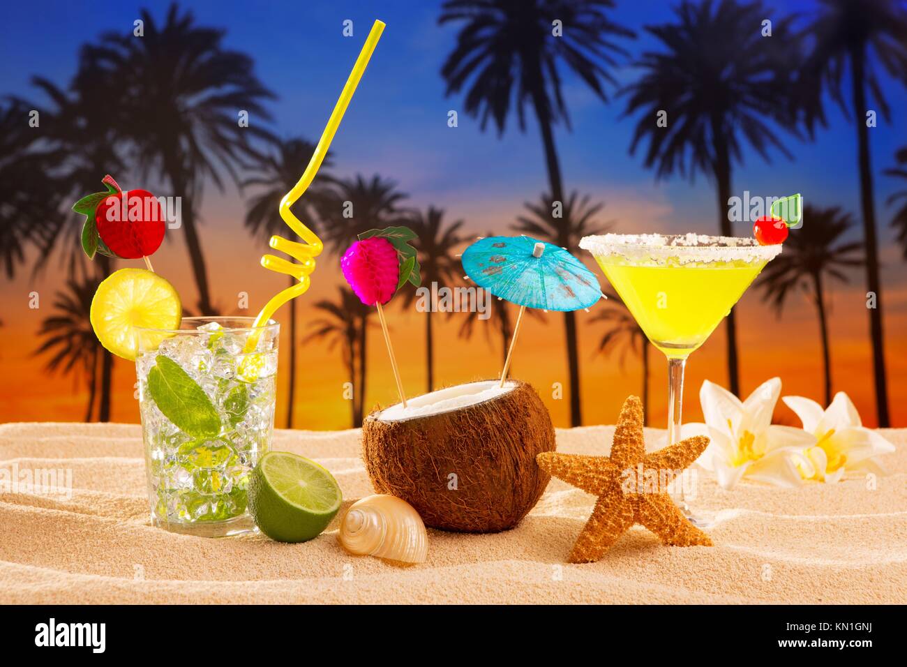beach cocktail sunset on palm tree sand mojito margarita coconut Stock
