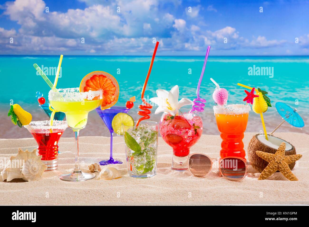 Colorful tropical cocktails at beach on white sand and turquoise water ...