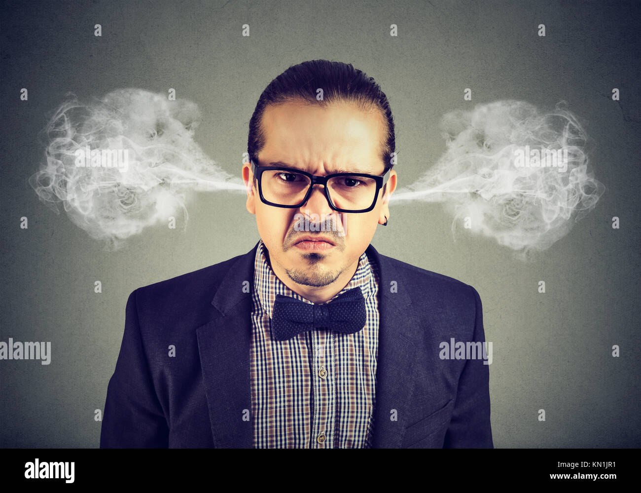 Angry business man, blowing steam coming out of ears, about to have nervous breakdown isolated on gray background. Negative emotions facial expression Stock Photo