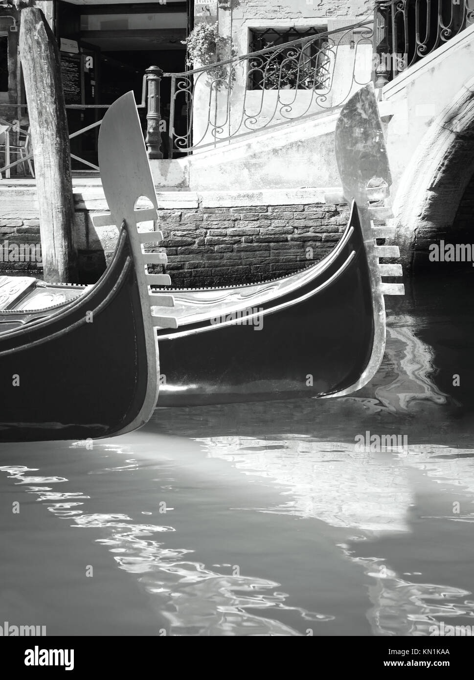 Characteristic angle of Venice with a detail of two gondola on the water in black and white Stock Photo