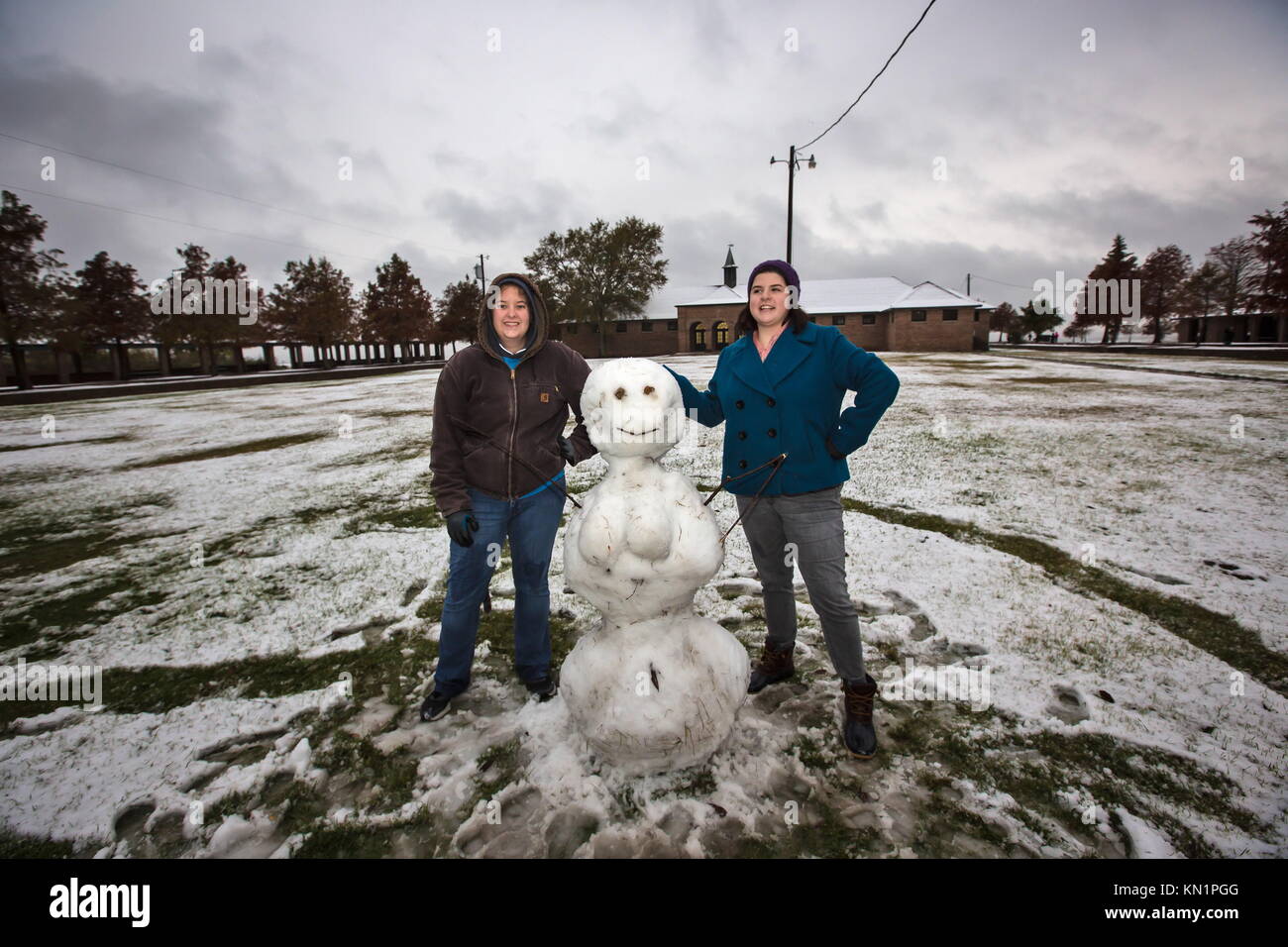 Mandeville, Louisiana, USA. 8th Dec, 2017. Molly Ganger and Rose Highnote pose with a snowman they built in the late afternoon on the shore of Lake Pontchartrain in Fontainebleau State Park. A wintry mix of precipitation fell across several Deep South states causing many businesses and schools to shut down. Credit: Julie Dermansky/ZUMA Wire/Alamy Live News Stock Photo