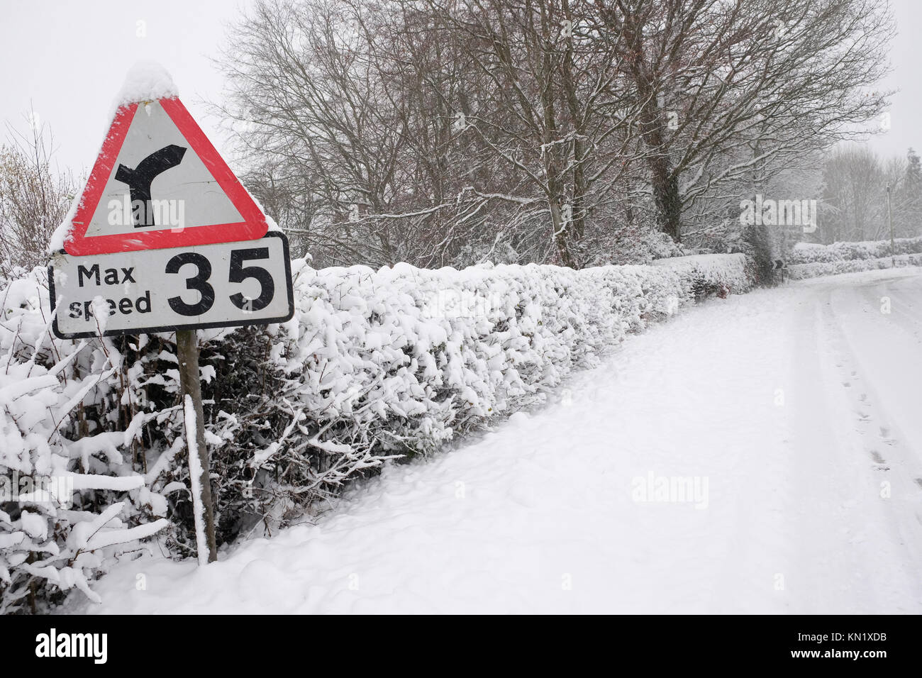 Titley, Herefordshire, UK - December 2017 - Danger bend road sign -  snow continues to fall onto the rural B4355 road between Kington Herefordshire and Presteigne Powys after many hours of snowfall overnight.  Road conditions are dangerous.  Photo  Steven May / Alamy Live News Stock Photo