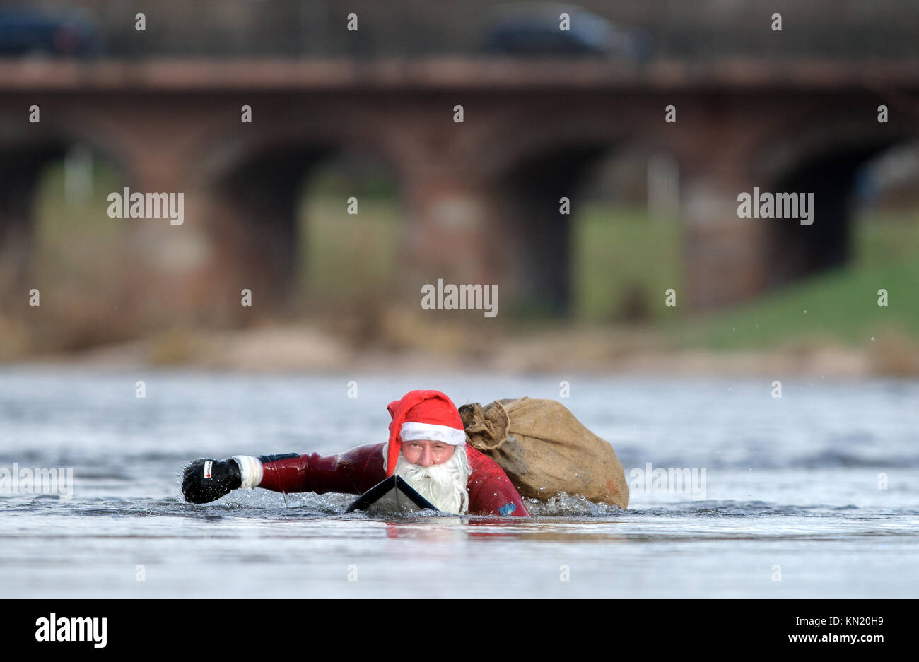 Rastatt, Germany. 09th Dec, 2017. The cold temperatures could not restrain Surfer Thomas Schmidt (50) from Rastatt in Germany going in the Murg-River in Rastatt to engage his passion Surfing. Dressed in a red neoprene Santa Claus suit Credit: dpa picture alliance/Alamy Live News Stock Photo