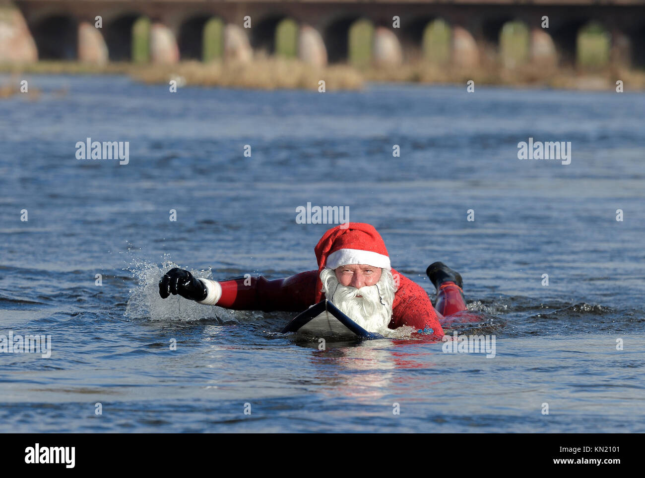 Rastatt, Germany. 09th Dec, 2017. The cold temperatures could not restrain Surfer Thomas Schmidt (50) from Rastatt in Germany going in the Murg-River in Rastatt to engage his passion Surfing. Dressed in a red neoprene Santa Claus suit Credit: dpa picture alliance/Alamy Live News Stock Photo